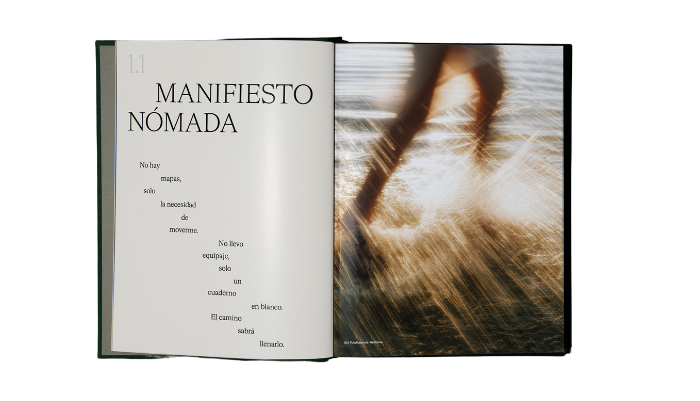 Open book showing page titled 'MANIFIESTO NÓMADA' beside a blurred action photo on the right page